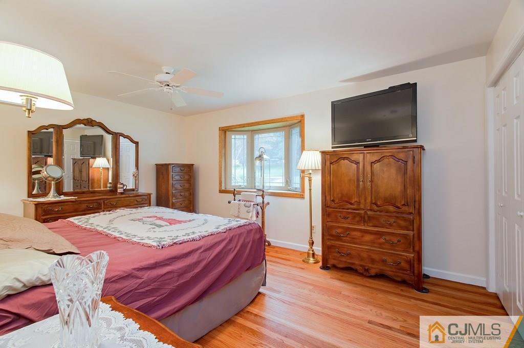 1670 Washington Valley Road Bridgewater, NJ 08836 - Photo 11 of 18 a bedroom with a bed and a flat screen tv