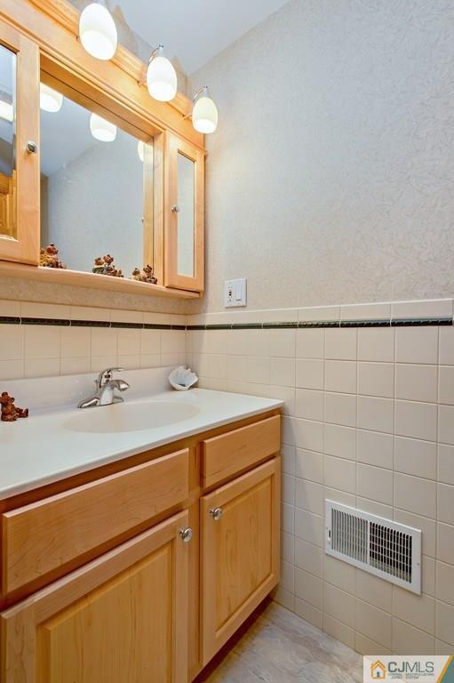 1670 Washington Valley Road Bridgewater, NJ 08836 - Photo 16 of 18 a bathroom with a sink and a mirror