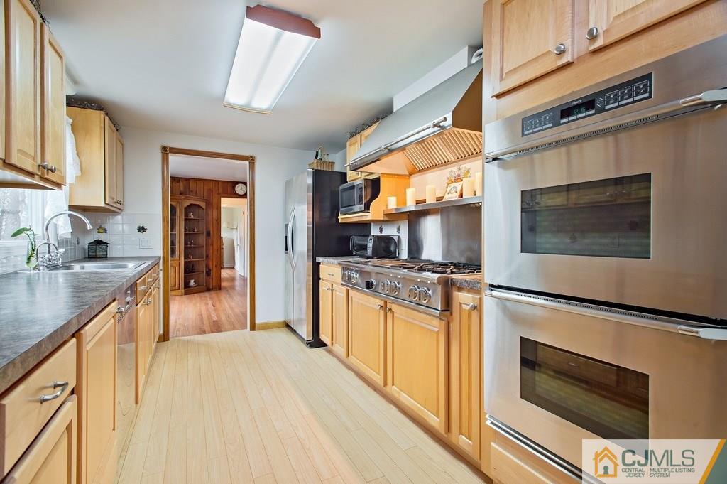 1670 Washington Valley Road Bridgewater, NJ 08836 - Photo 3 of 18 a kitchen with stainless steel appliances granite countertop a stove microwave and sink