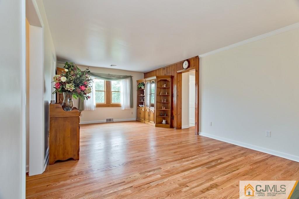 1670 Washington Valley Road Bridgewater, NJ 08836 - Photo 4 of 18 a view of an empty room with wooden floor and a window