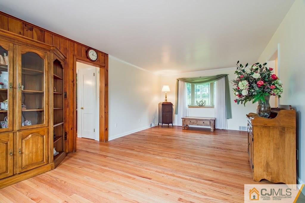 1670 Washington Valley Road Bridgewater, NJ 08836 - Photo 5 of 18 a view of an empty room with a window and wooden floor