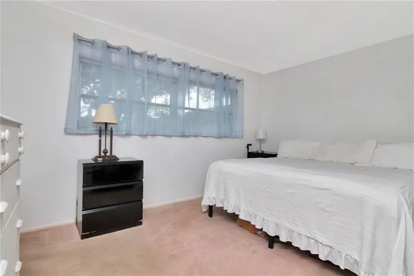 a bed room with a bed and a chandelier