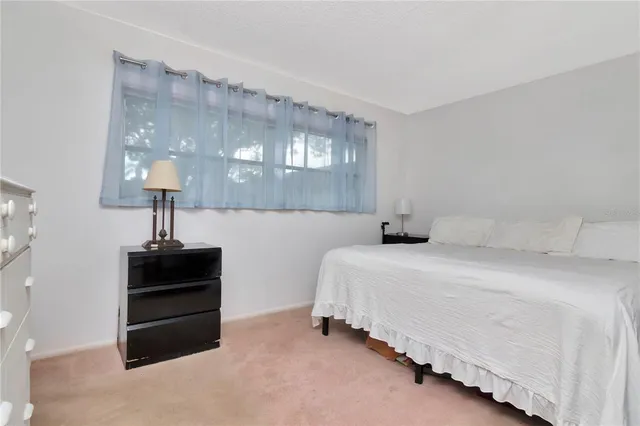 a bed room with a bed and a chandelier