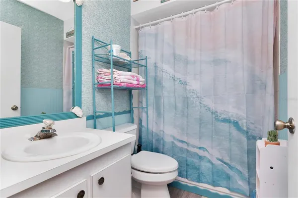 a bathroom with a sink toilet and shower