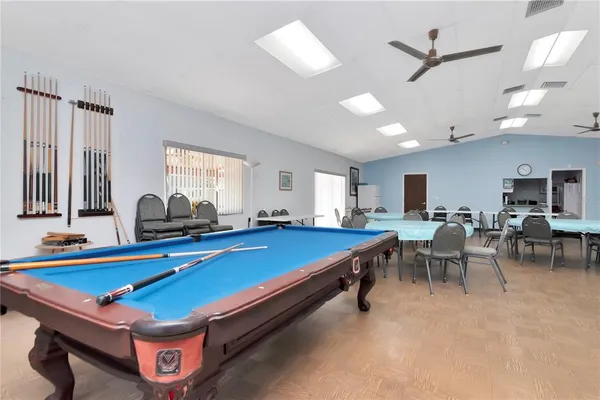 a room with furniture pool table and windows