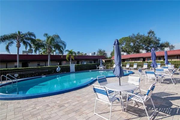 a view of a swimming pool with chairs