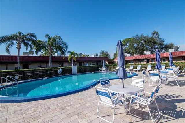 a view of a swimming pool with chairs