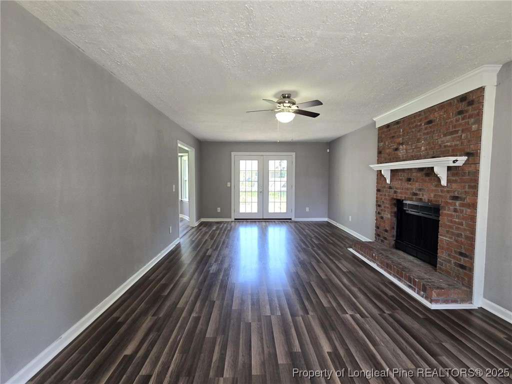 7132 Dayspring Drive Fayetteville, NC 28314 - Photo 12 of 44 wooden floor in an empty room with a fireplace