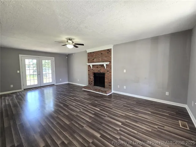 wooden floor in an empty room with a fireplace