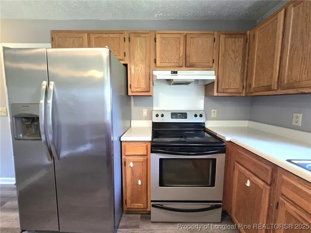 a kitchen with a stove and a refrigerator