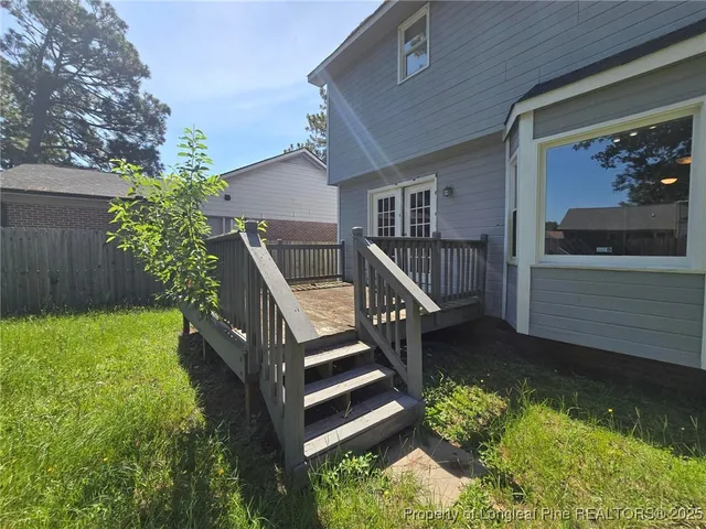a view of a house with backyard and porch