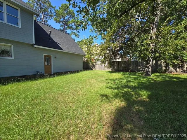 a backyard of a house with lots of green space