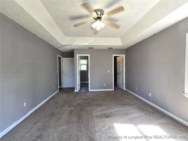 a view of a livingroom with a chandelier fan