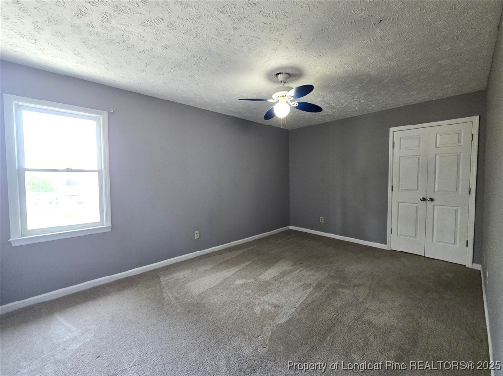 7132 Dayspring Drive Fayetteville, NC 28314 - Photo 40 of 44 an empty room with a window and a ceiling fan