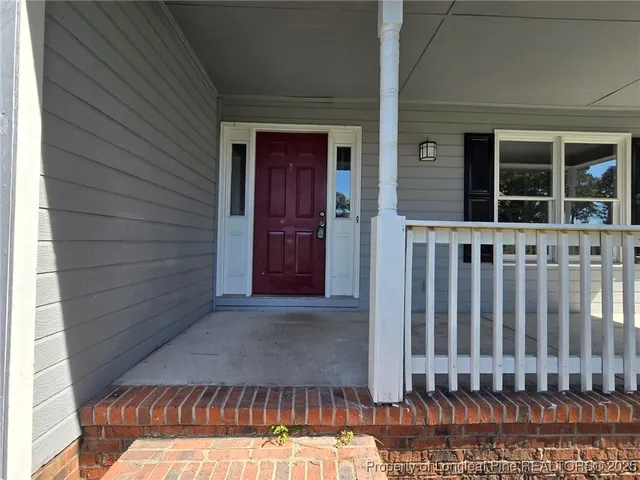 a view of a house with wooden fence