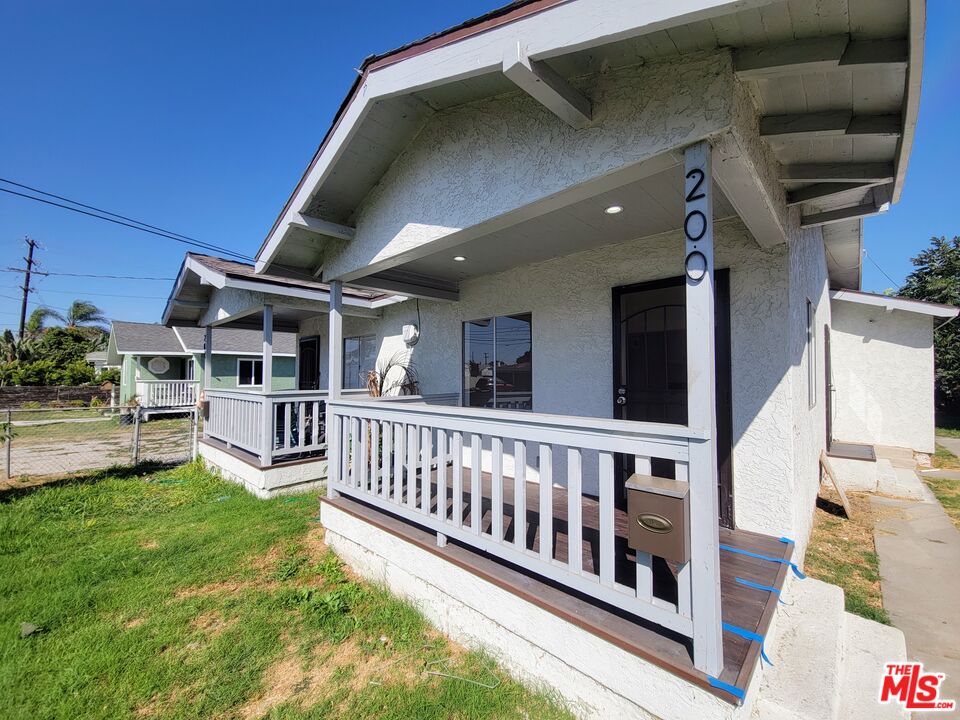 a view of a house with pool and deck
