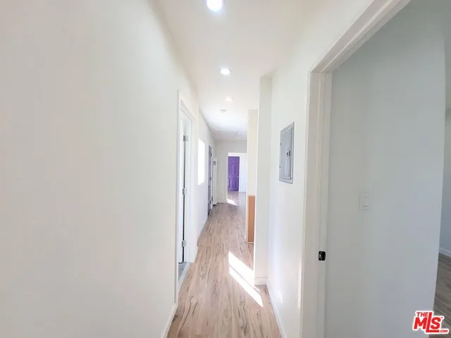 a view of a hallway with wooden floor