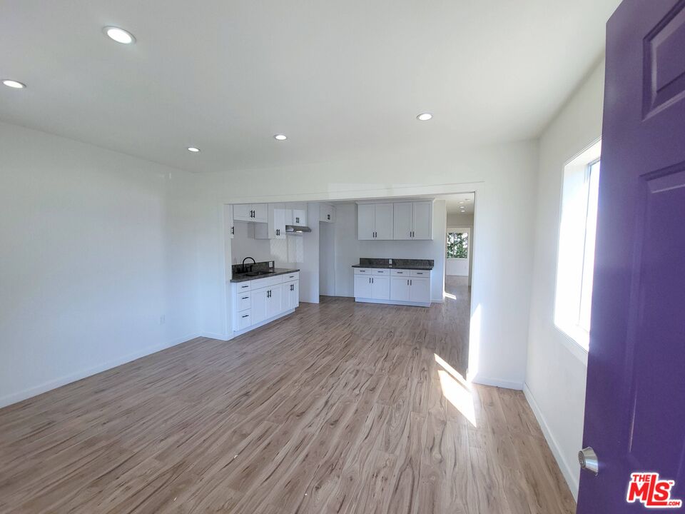 200 North Acacia Avenue Compton, CA 90220 - Photo 2 of 18 a open kitchen with white cabinets and wooden floor