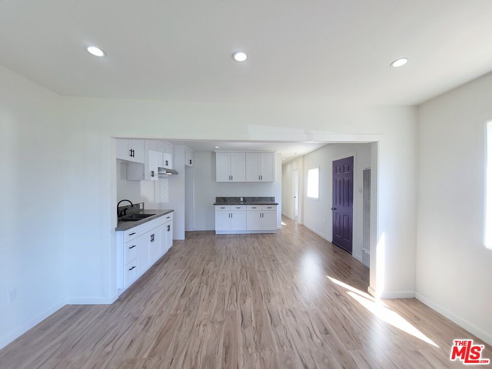 200 North Acacia Avenue Compton, CA 90220 - Photo 3 of 18 a kitchen with granite countertop a stove a sink and a refrigerator