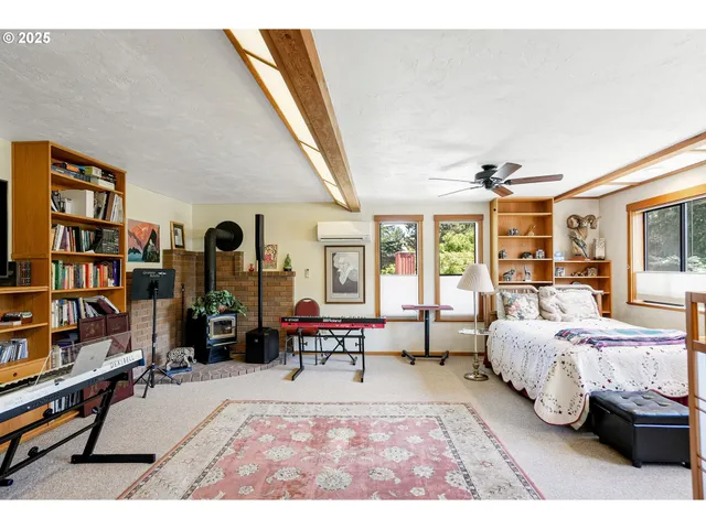 a bedroom with furniture and a book shelf