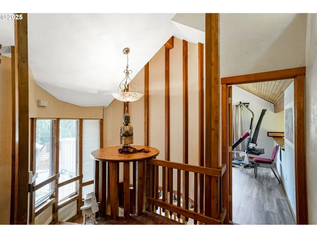 a view of a living room with furniture and wooden floor