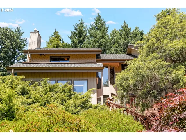 a view of a house with a flower garden