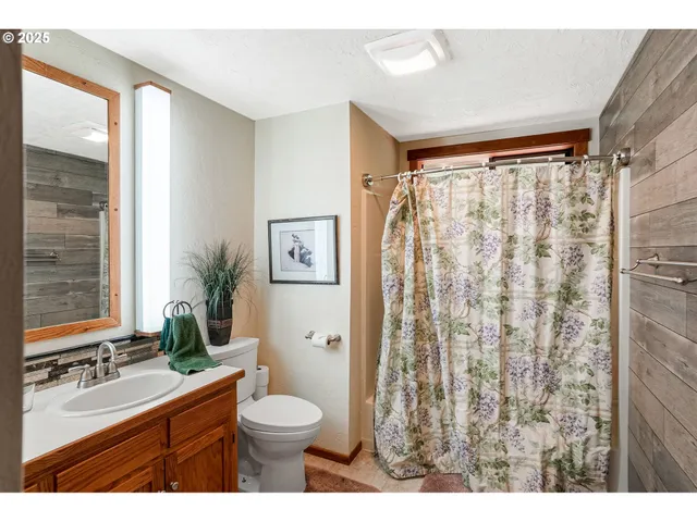 a bathroom with a double vanity sink toilet and shower