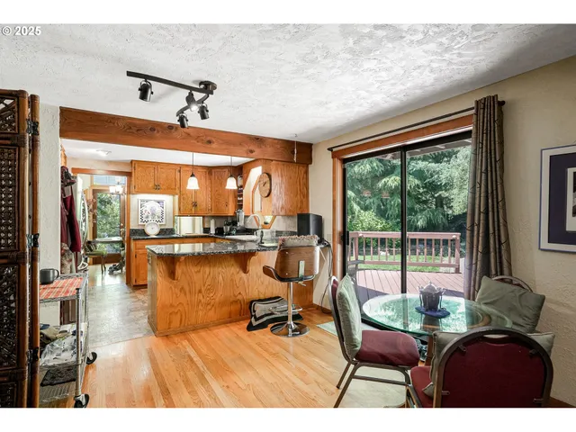 a living room with furniture a floor to ceiling window and outdoor view