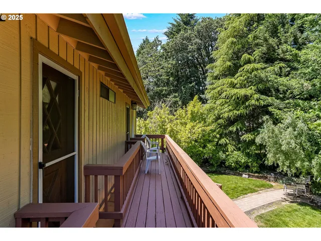 a view of balcony with wooden floor and fence