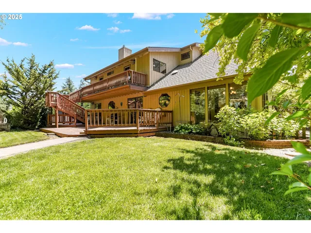 a view of a house with a large pool and a yard