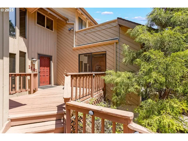 a view of a brick house with a small yard