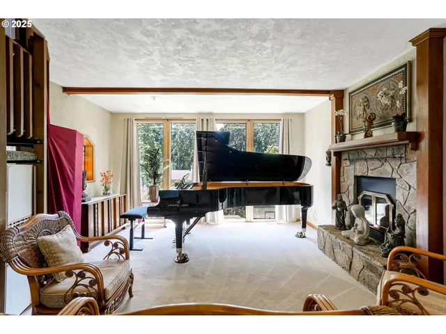 a living room with furniture a large window and a fireplace