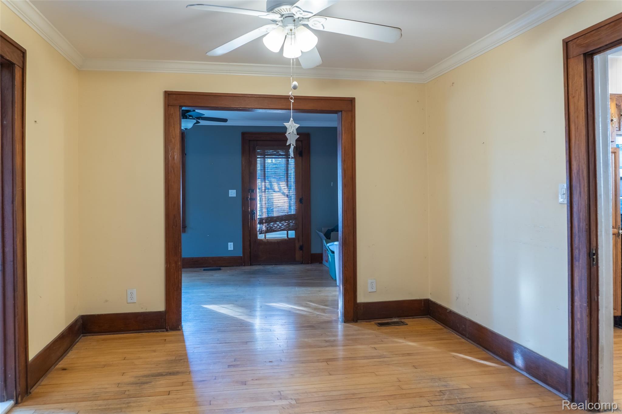 1846 North Gulley Road Dearborn, MI 48128 - Photo 10 of 32 Spare room featuring light wood-style floors, crown molding, and ceiling fan