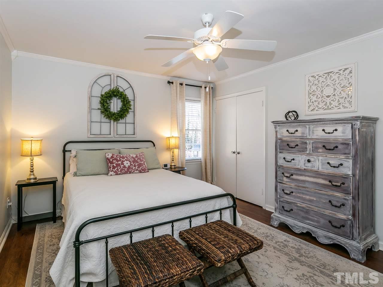 7705 Prospector Place Raleigh, NC 27615 - Photo 12 of 30 a bedroom with a bed chandelier and a window