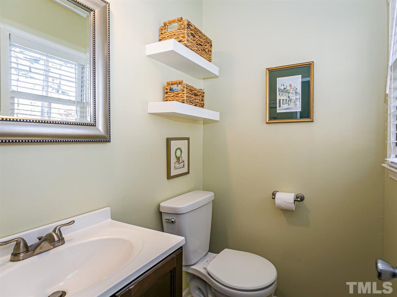 7705 Prospector Place Raleigh, NC 27615 - Photo 15 of 30 a bathroom with a sink mirror and toilet