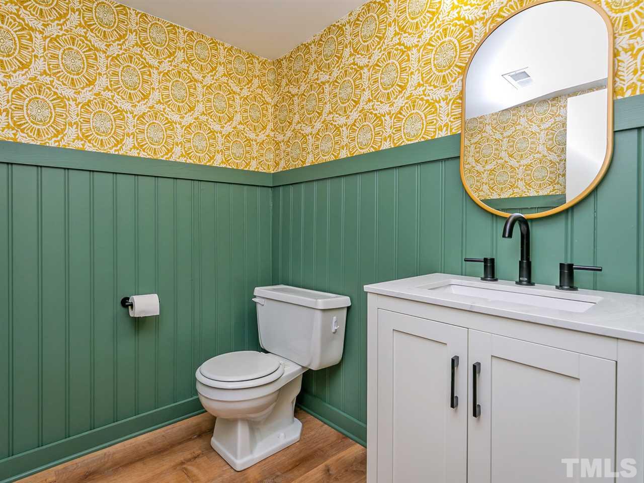 7705 Prospector Place Raleigh, NC 27615 - Photo 20 of 30 a bathroom with a toilet a sink and garden