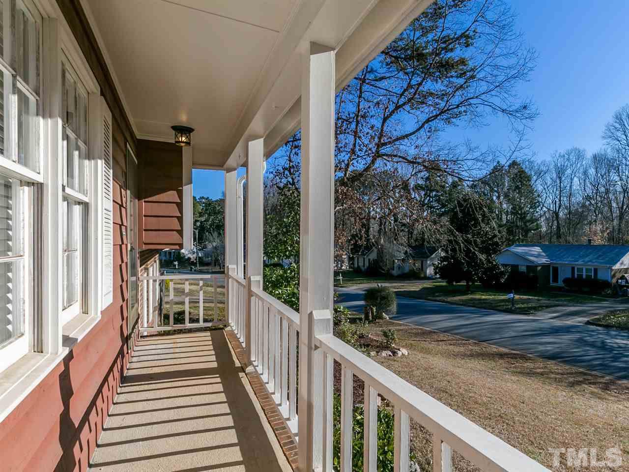 7705 Prospector Place Raleigh, NC 27615 - Photo 3 of 30 a view of a porch with wooden floor and fence