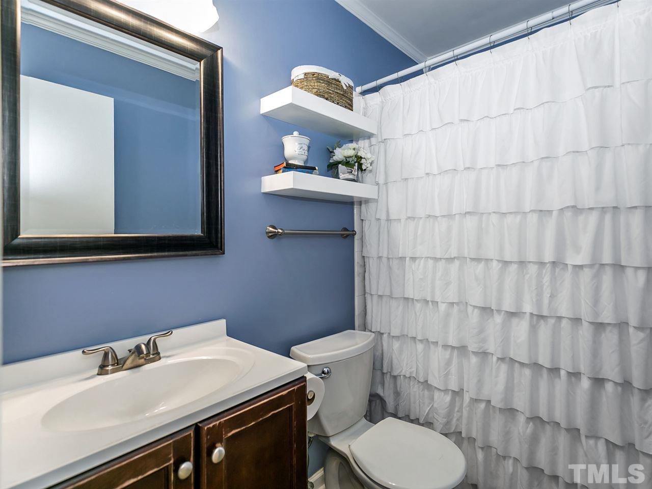 7705 Prospector Place Raleigh, NC 27615 - Photo 23 of 30 a bathroom with a sink a toilet and a mirror