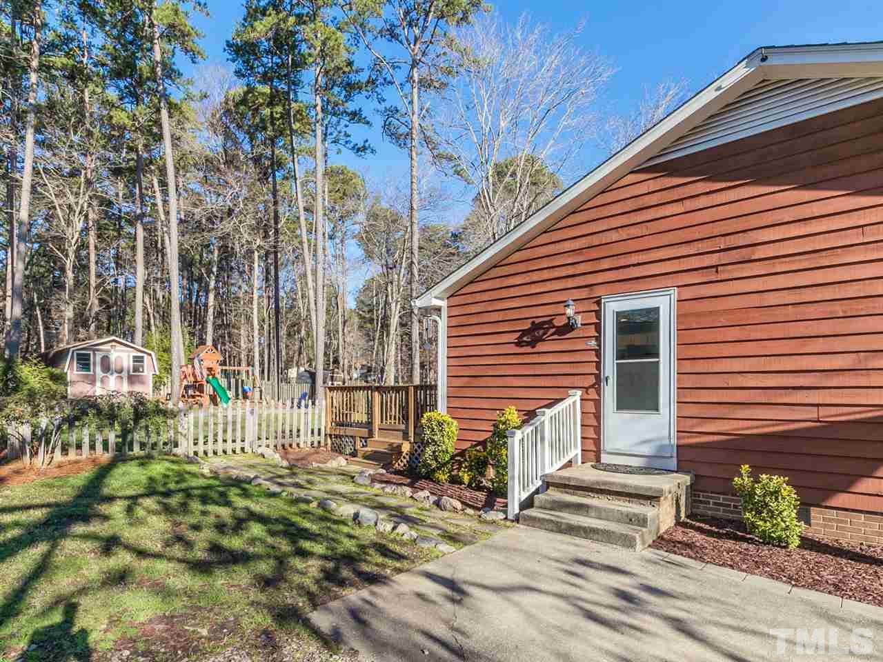 7705 Prospector Place Raleigh, NC 27615 - Photo 26 of 30 a view of a house with a small yard and wooden floor and fence