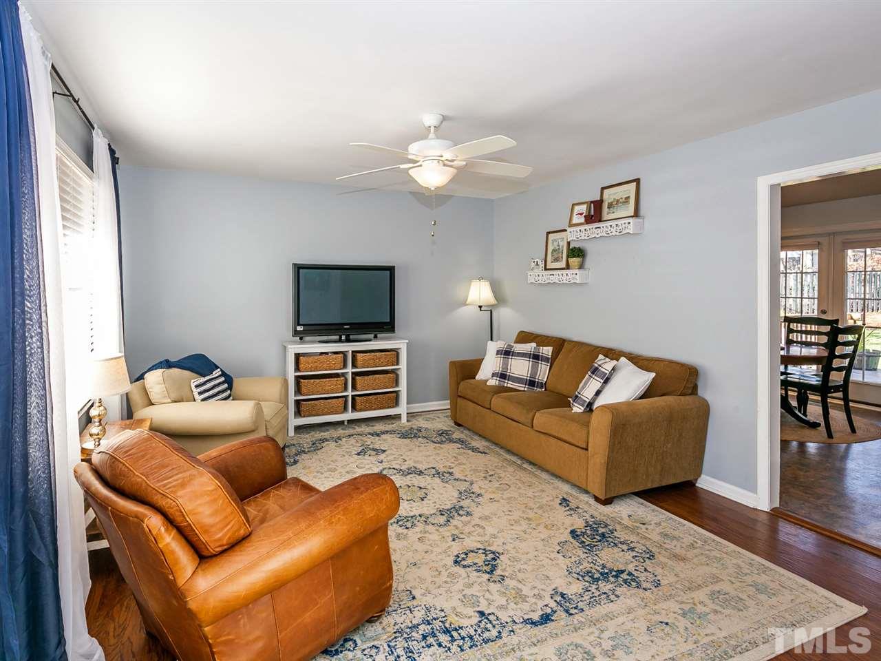 7705 Prospector Place Raleigh, NC 27615 - Photo 7 of 30 a living room with furniture and a flat screen tv