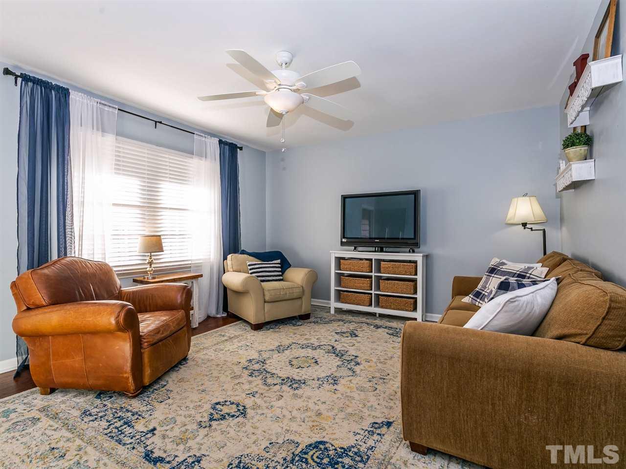 7705 Prospector Place Raleigh, NC 27615 - Photo 8 of 30 a living room with furniture and a flat screen tv