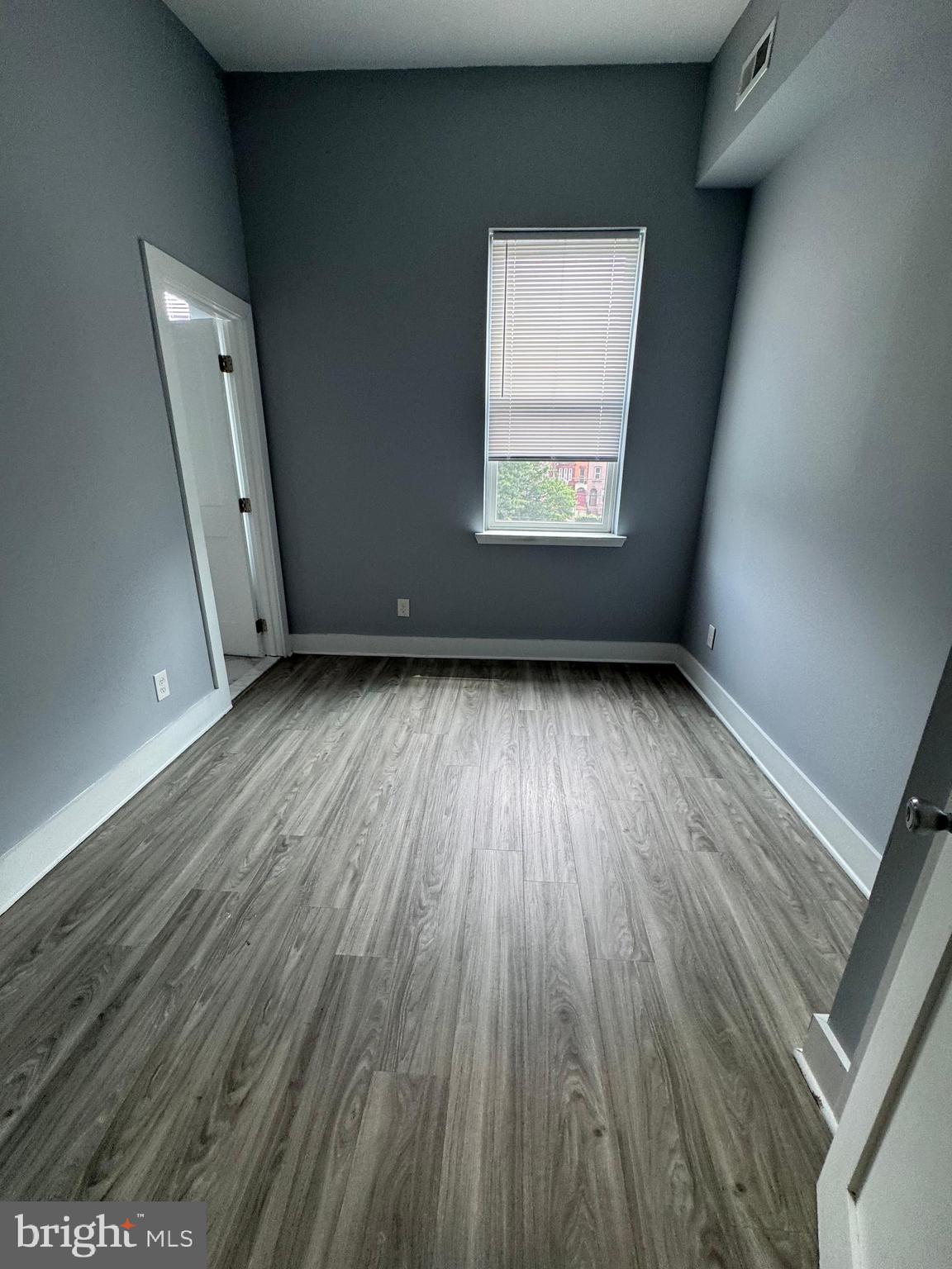 1522 Willington Street, Unit 2 Philadelphia, PA 19121 - Photo 11 of 29 an empty room with wooden floor and windows