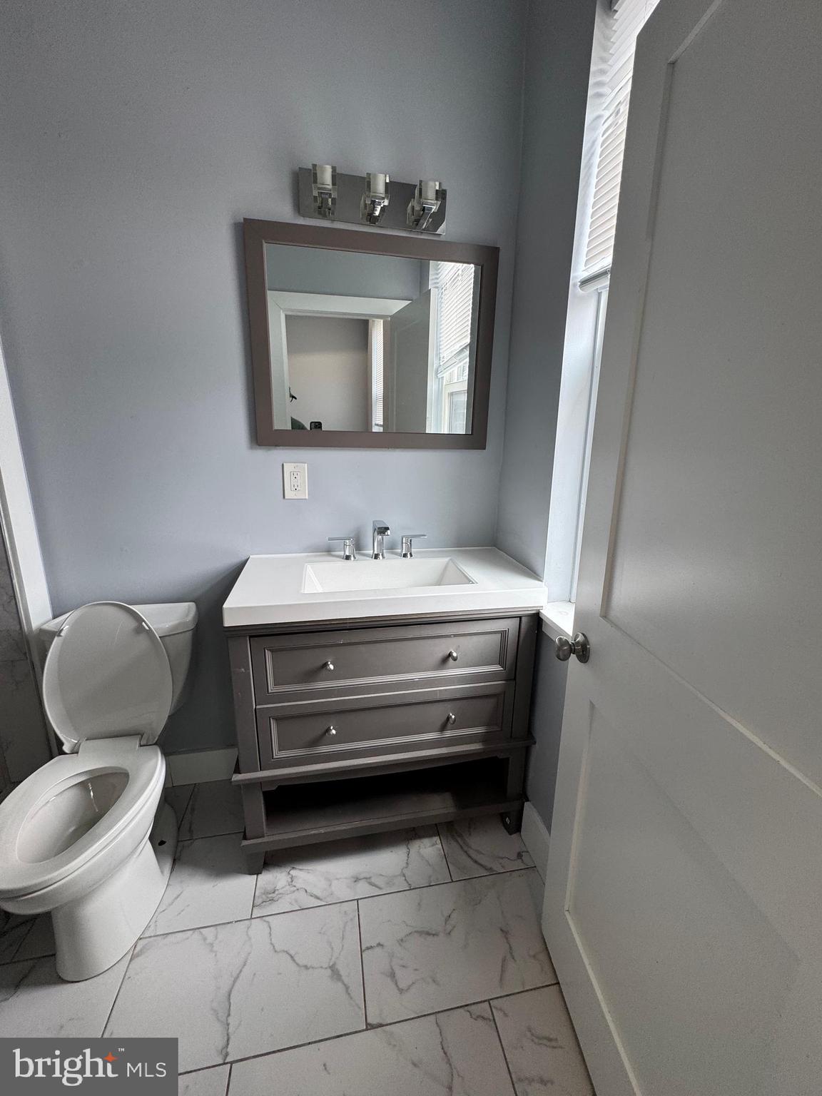 1522 Willington Street, Unit 2 Philadelphia, PA 19121 - Photo 13 of 29 a bathroom with a toilet sink and mirror
