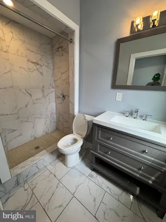 a bathroom with a sink mirror vanity and toilet