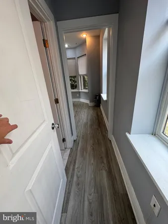 a view of a hallway view with wooden floor and staircase