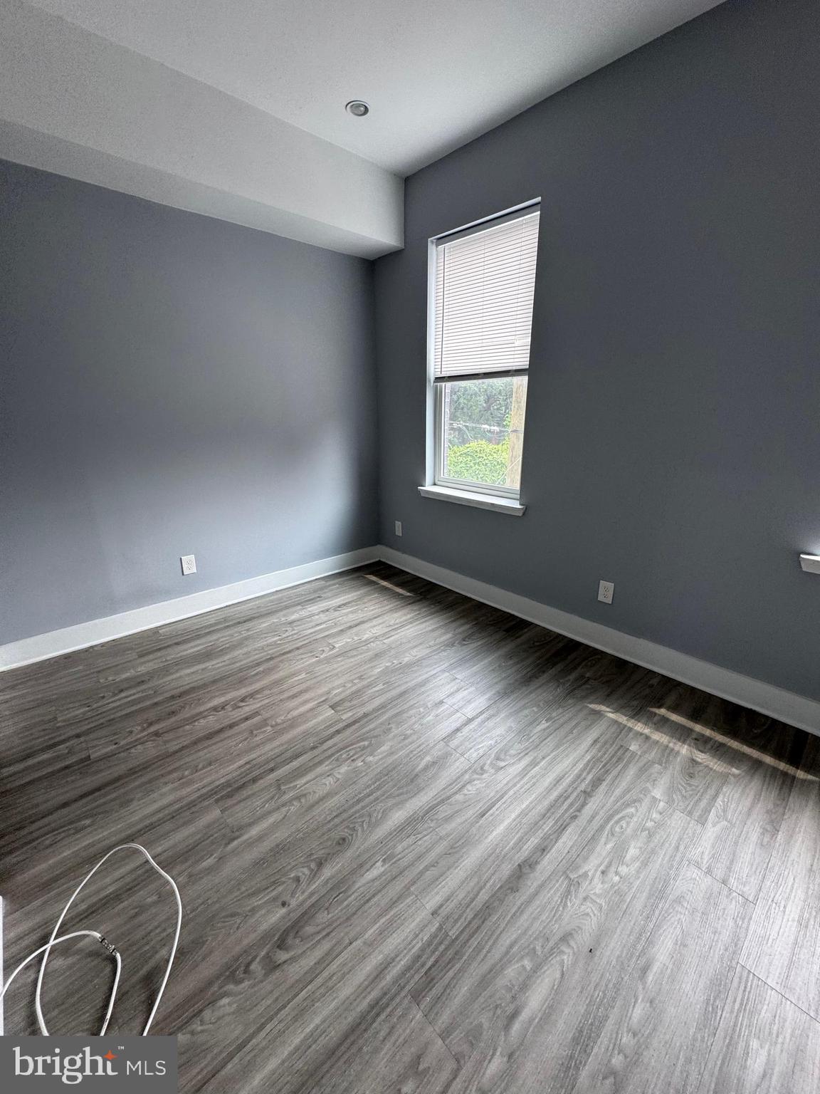1522 Willington Street, Unit 2 Philadelphia, PA 19121 - Photo 23 of 29 an empty room with wooden floor and windows