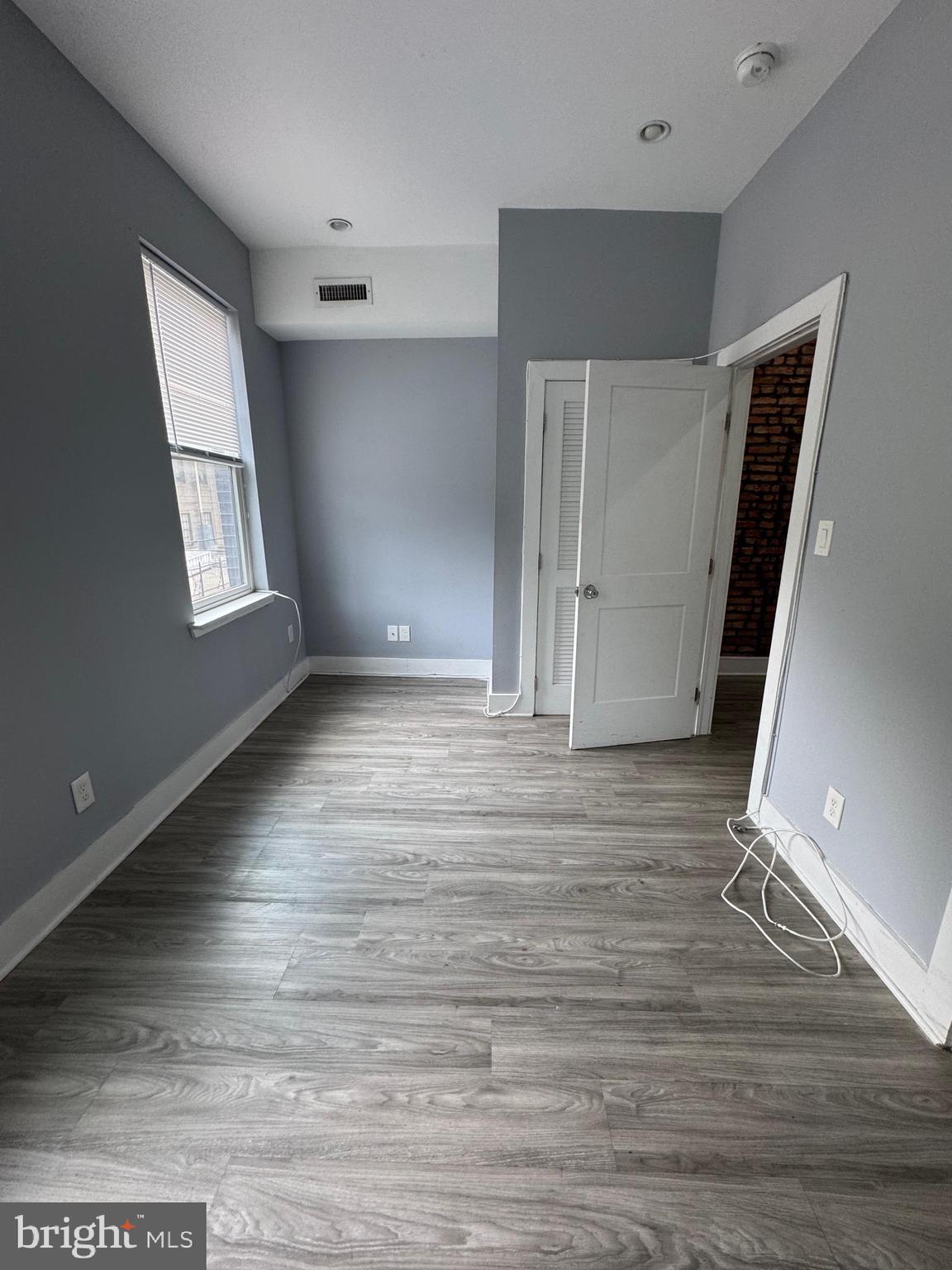 1522 Willington Street, Unit 2 Philadelphia, PA 19121 - Photo 24 of 29 an empty room with wooden floor and windows