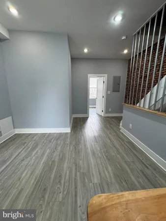 a view of hallway with stairs and wooden floor