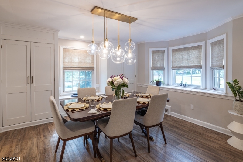200 Wychwood Road Westfield, NJ 07090 - Photo 6 of 31 a dining room with furniture a chandelier and wooden floor