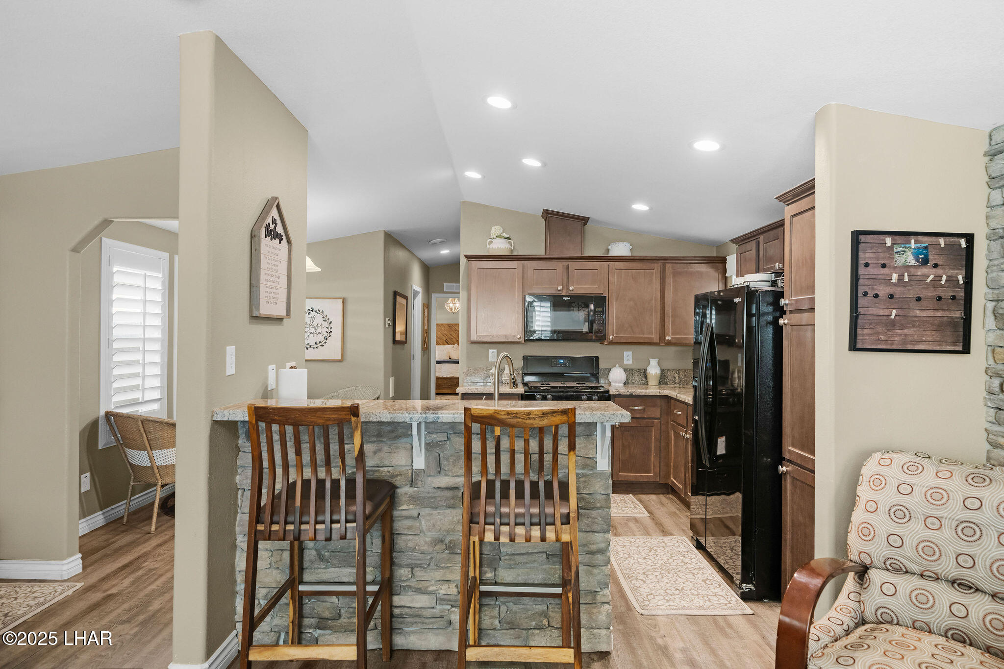3020 Parker Dam Road, Unit 11 Parker, AZ 85344 - Photo 12 of 58 a kitchen with stainless steel appliances kitchen island granite countertop a refrigerator and microwave